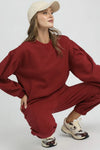 Burgundy Sweatshirt with Pleated Detail-Cozy meets chic in this burgundy pleated sweatshirt. A fall-ready round neck pullover with soft sleeve details, perfect for layering or lounging. Sizes XS–L.-Reef Love Boutique