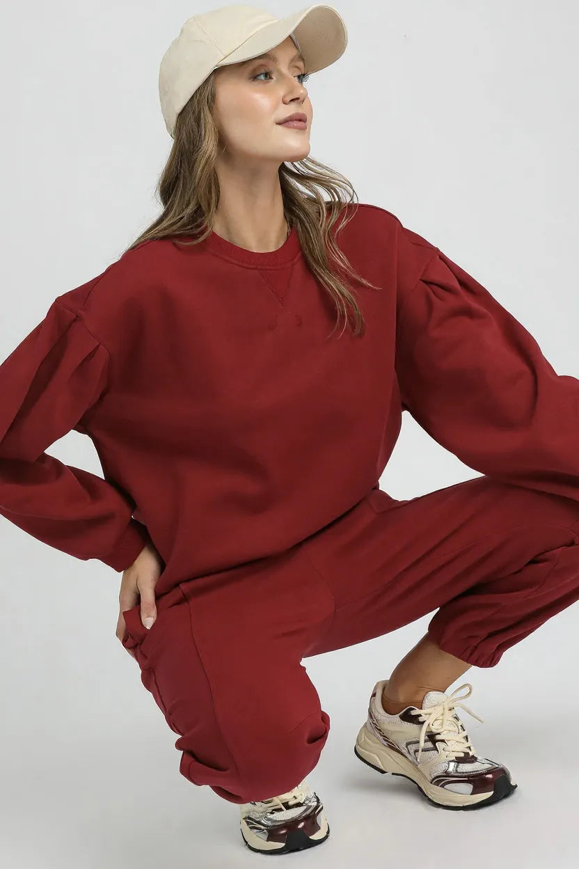 Burgundy Sweatshirt with Pleated Detail-Cozy meets chic in this burgundy pleated sweatshirt. A fall-ready round neck pullover with soft sleeve details, perfect for layering or lounging. Sizes XS–L.-Reef Love Boutique