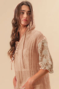 Woman wearing Jacquard Flower Puff Sleeve Hooded Knit Top-This jacquard flower puff sleeve hooded knit top combines intricate floral patterns with a touch of volume in the sleeves for a stylish look, elevate your knitwear.