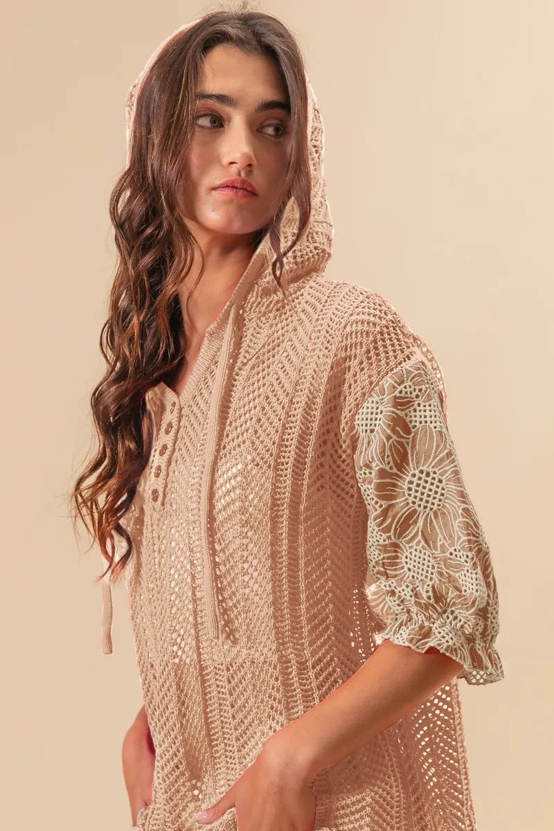Woman wearing Jacquard Flower Puff Sleeve Hooded Knit Top-This jacquard flower puff sleeve hooded knit top combines intricate floral patterns with a touch of volume in the sleeves for a stylish look, elevate your knitwear.