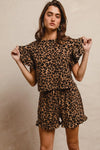 Woman wearing Leopard Print Waffle Texture Layered Ruffle Sleeve Top and Shorts Set-This leopard print set features a leopard print waffle texture top with layered ruffle sleeves, paired with matching shorts for a coordinated and stylish look. 