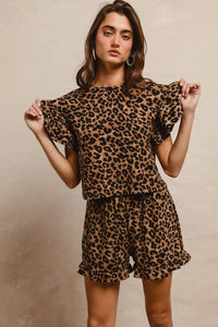 Woman wearing Leopard Print Waffle Texture Layered Ruffle Sleeve Top and Shorts Set-This leopard print set features a leopard print waffle texture top with layered ruffle sleeves, paired with matching shorts for a coordinated and stylish look. 