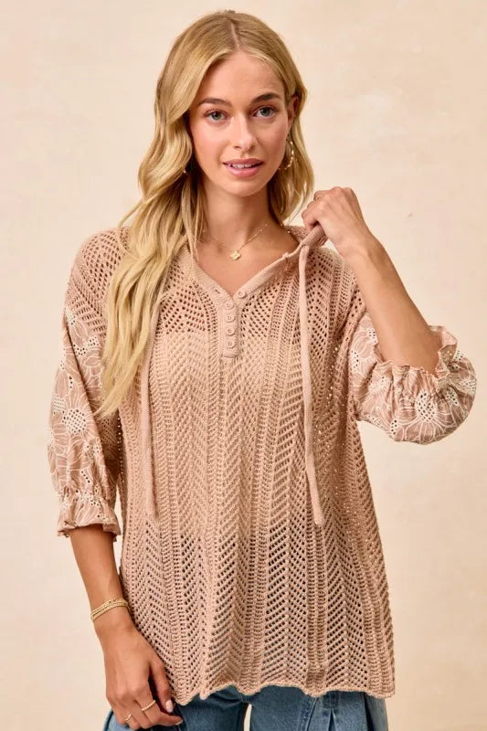 Woman wearing Jacquard Flower Puff Sleeve Hooded Knit Top-This jacquard flower puff sleeve hooded knit top combines intricate floral patterns with a touch of volume in the sleeves for a stylish look, elevate your knitwear.