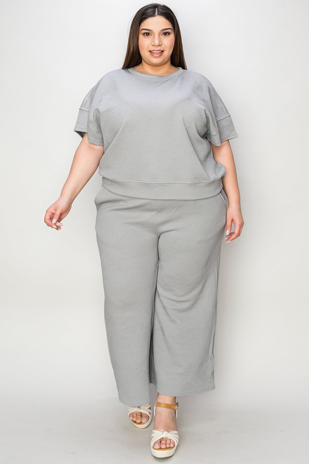 Textured, stretchy, and comfy. This two piece cropped pant with short sleeve top is a great travel set to stay comfortable in the car or plane. Available in a variety of colors and extended sizes.