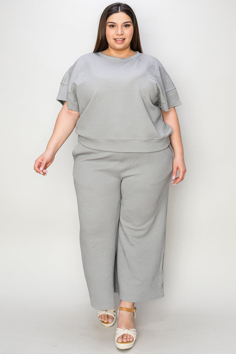 Textured, stretchy, and comfy. This two piece cropped pant with short sleeve top is a great travel set to stay comfortable in the car or plane. Available in a variety of colors and extended sizes.