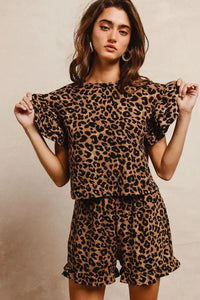 Woman wearing Leopard Print Waffle Texture Layered Ruffle Sleeve Top and Shorts Set-This leopard print set features a leopard print waffle texture top with layered ruffle sleeves, paired with matching shorts for a coordinated and stylish look. 
