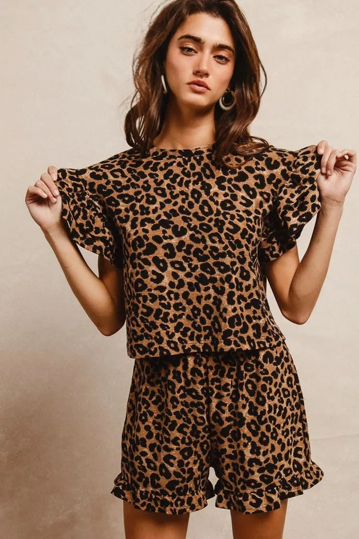 Woman wearing Leopard Print Waffle Texture Layered Ruffle Sleeve Top and Shorts Set-This leopard print set features a leopard print waffle texture top with layered ruffle sleeves, paired with matching shorts for a coordinated and stylish look. 